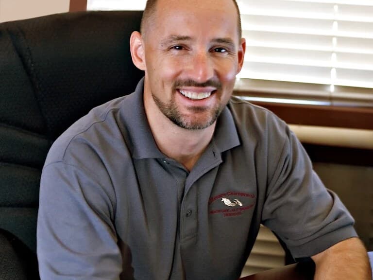 Dr. James Bogash seated at his desk at LifeCare Chiropractic.
